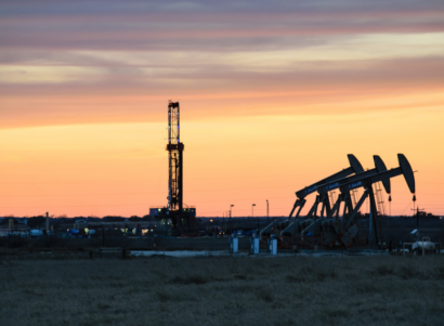 Oil and gas wells drilled and fracking during a sunset