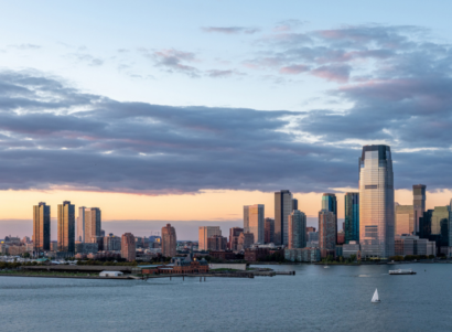 Landscape view of Jersey City and the Hudson River while the sun sets.