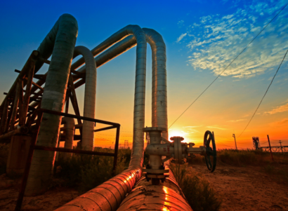 Oil pipelines in the desert during a sunset