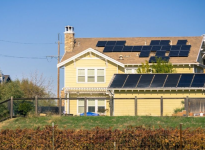 Yellow house with solar panels installed on the roof.