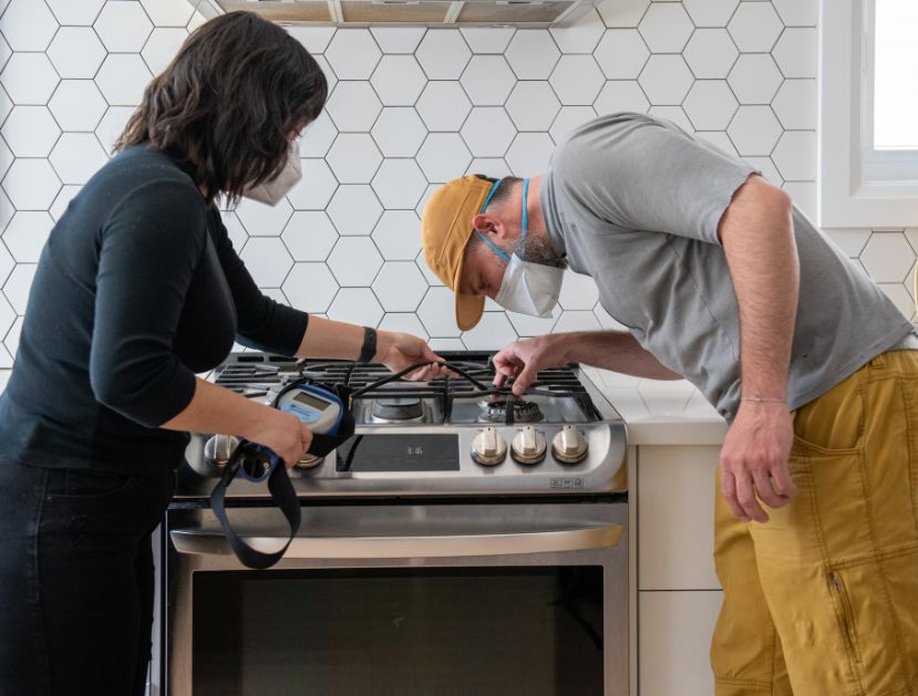 Two PSE researchers sample a gas stove