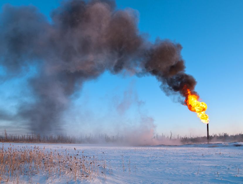 Picture of an natural gas flare burning and creating smoke