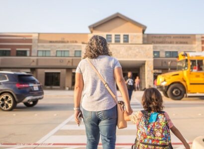 Image of a mother and child walking into a school