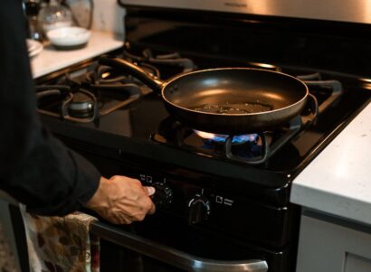 Image of a person lighting a gas stove.