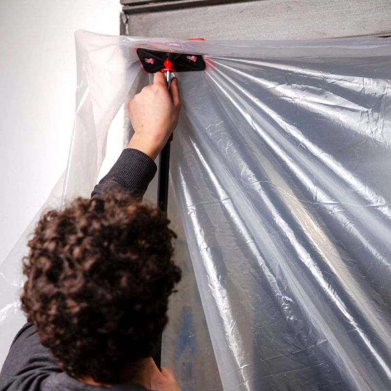 Image of plastic hosing secured to the ceiling of a kitchen.
